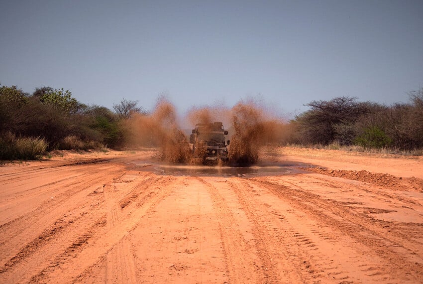 CAr driving through mud pool, Namibia