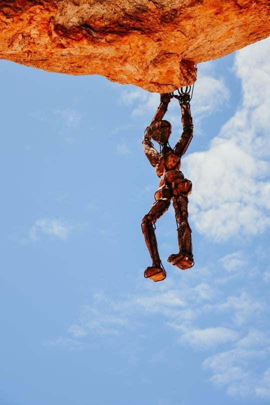 Stone figure perched on a cliff edge in Namibia’s wild Kaokoveld