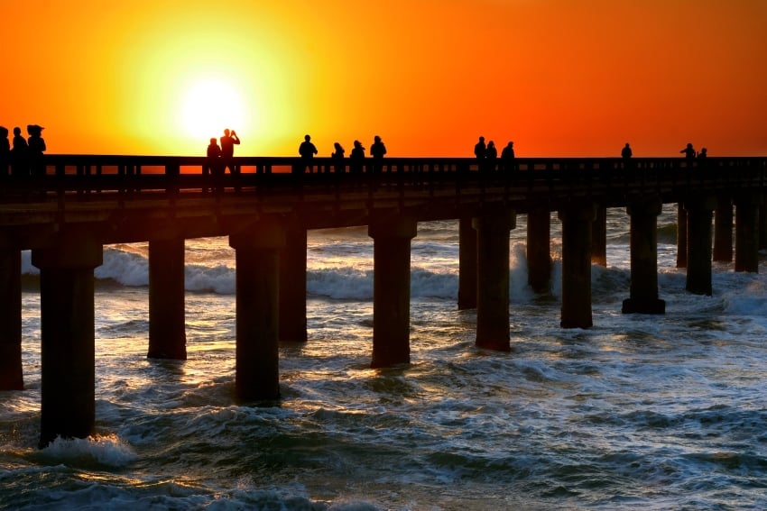 Fiery sunset at the Namibian coast with silhouettes of people