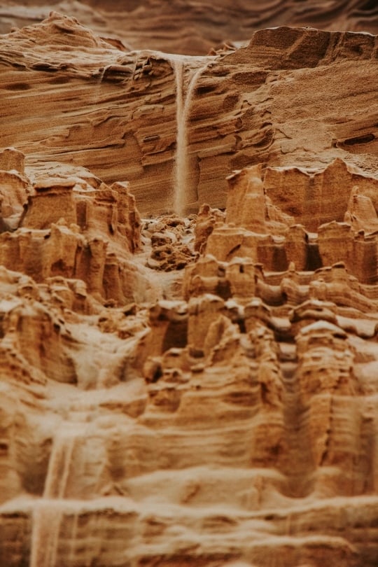 Massive, steep golden sand dunes of the Dorob National Park stretching toward the horizon.