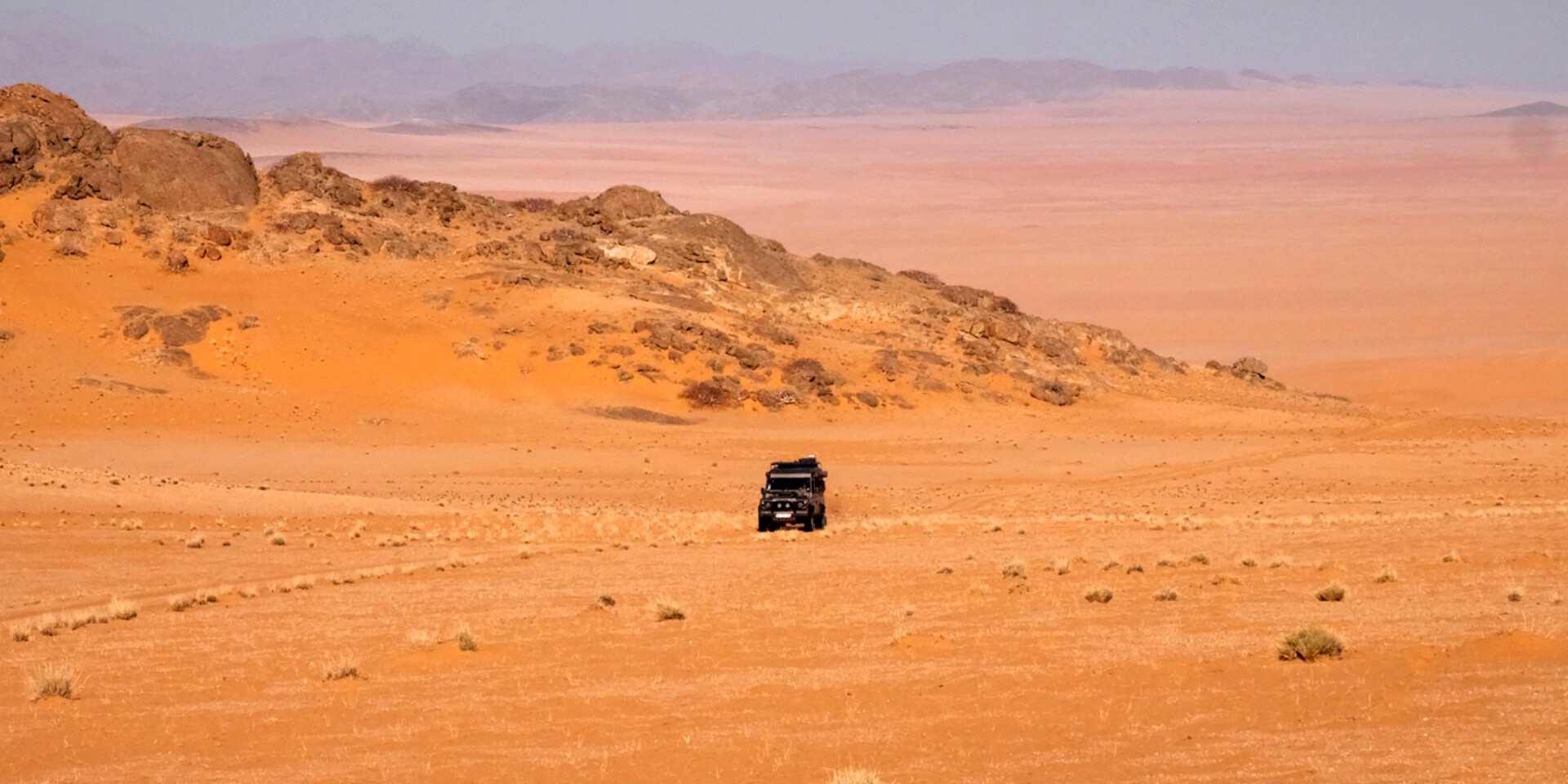 Jeep in the sand dunes of Namib Desert, Namibia