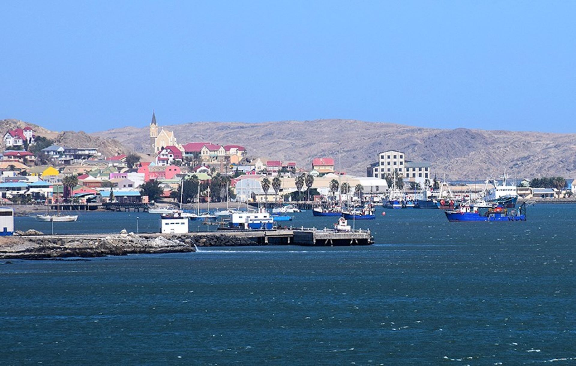 Docked boats lining the calm waterfront in Lüderitz, Namibia. 