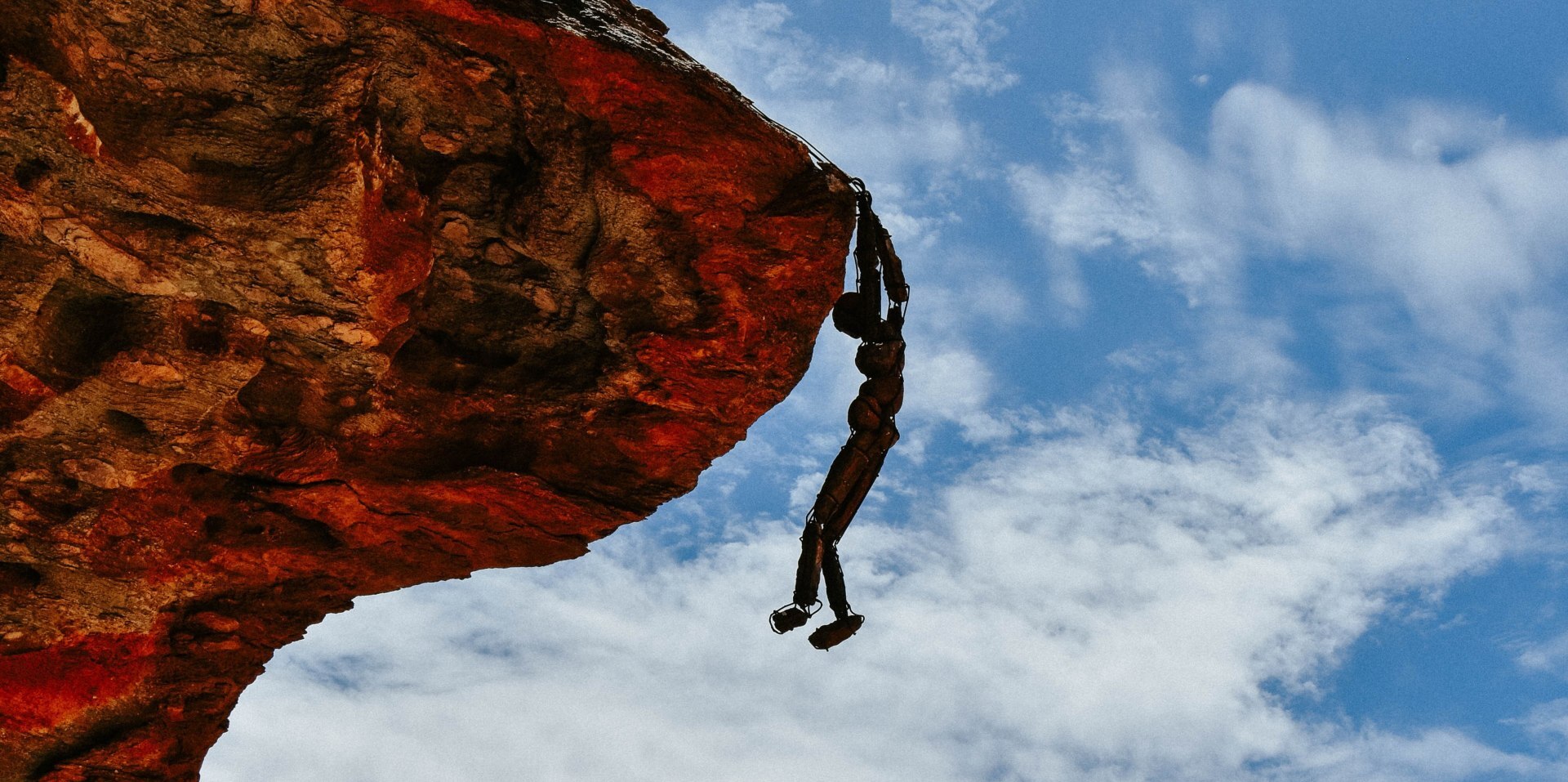 Stone “lone man” sculpture standing in the rugged Kaokoland, Namibia landscape