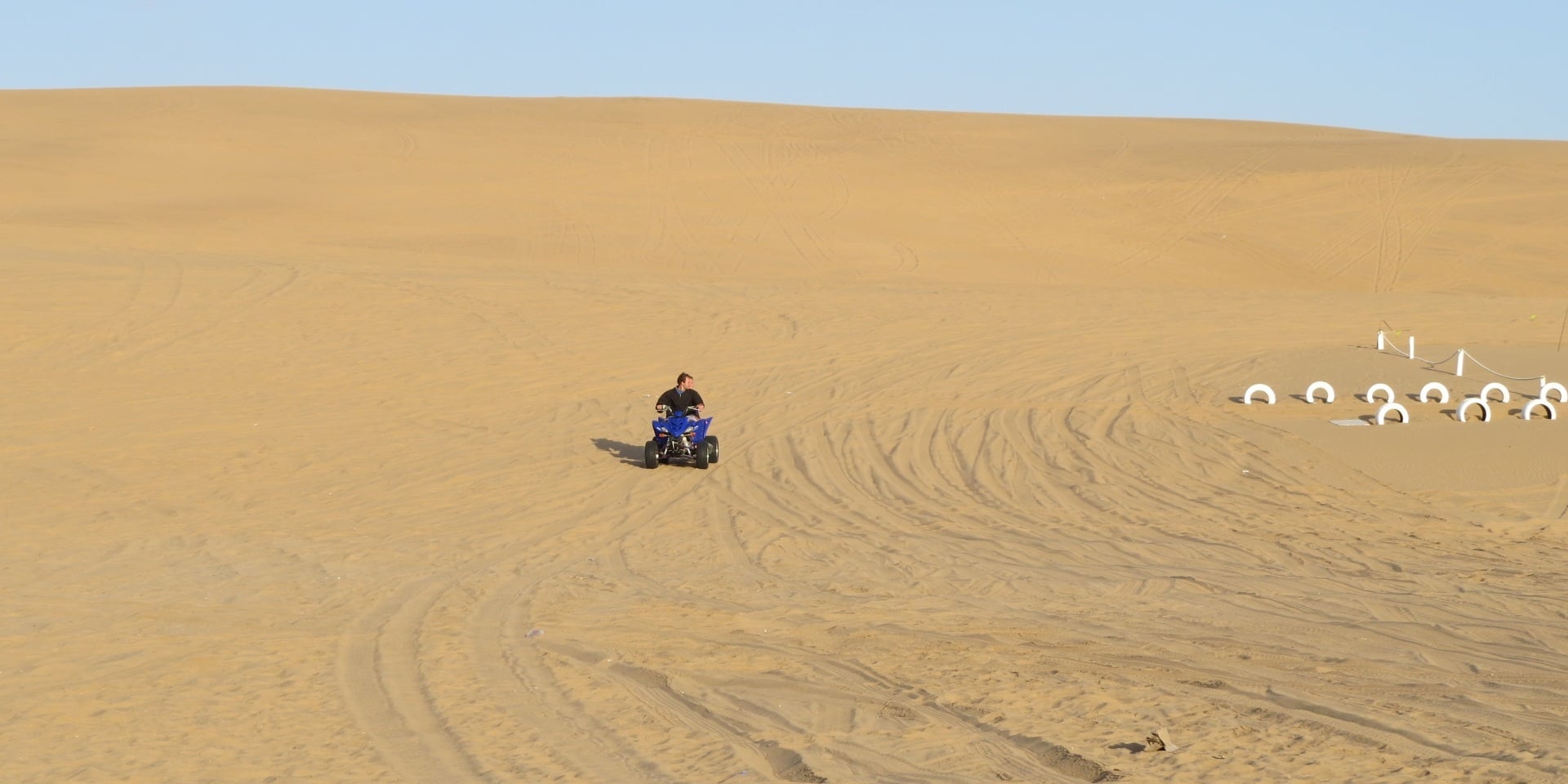 Quad biking across the sand dunes near Swakopmund, Namibia